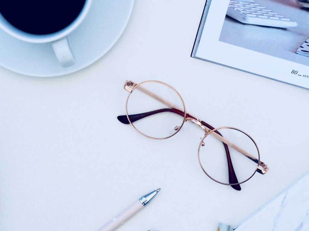 eyeglasses on desk in blue